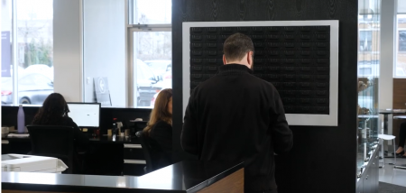 Man taking keys from the cabinet in a Car Dealership